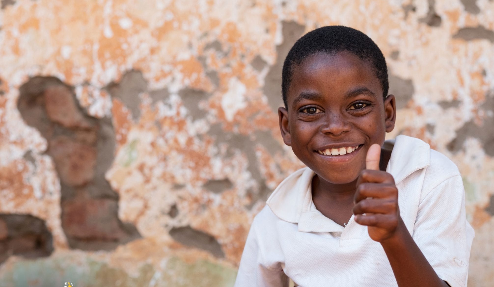Boy sits in with thumbs up