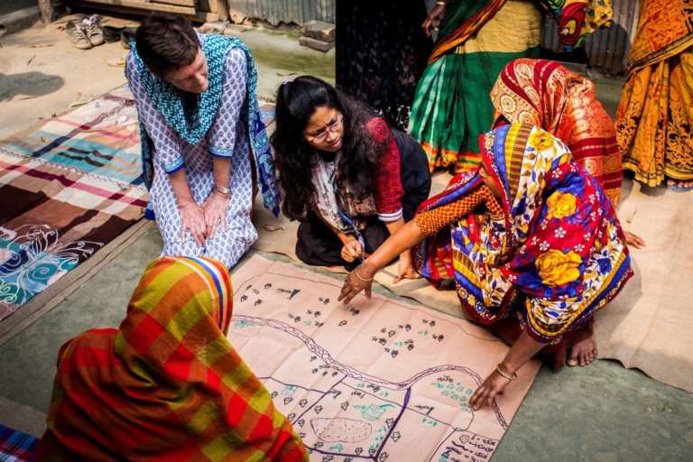 CBM staff member working with partners and communities in Bangladesh during a community disaster risk reduction planning exercise.