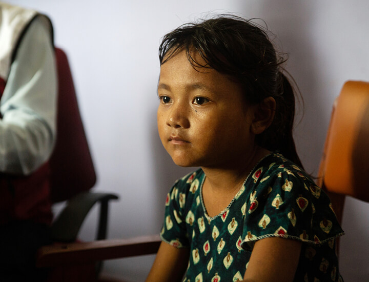 Aashika sitting on a chair