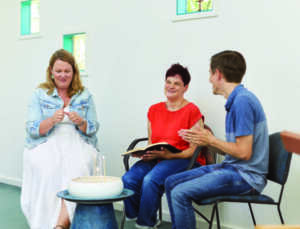 Mariska, Stevie and Joe sitting together and praying