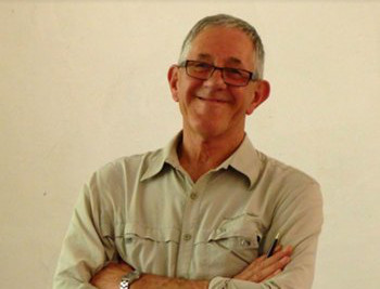 Dr Victor Wall smiling with his arms crossed.
