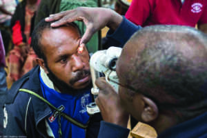 A doctor using specialise equipment to check Jack's eye