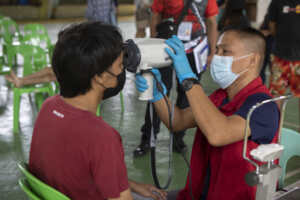 Here, ophthalmic technician Kim Gerangue (in red CMB jacket) examines Armon’s eyes at a community cataract screening camp organized by CBM partner Eye Hear Foundation in the Bacolod city, Philippines.
Please refer to PHL-22-MiraclesDayTrip-FieldStory for more information.