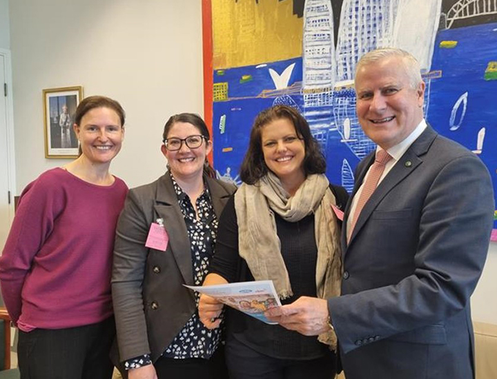 Christina Parasyn (ADDC co-chair), Kerryn Clarke (ADDC Executive Officer), Renee Dodds (CBM Acting Head of Policy and Advocacy) and Michael McCormack (Shadow Minister for International Development and the Pacific) all smile and look at a copy of the joint policy recommendations 