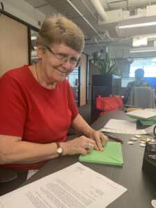 Sue Reid packing Eternal Giving Club gift in will packs for our supporters.