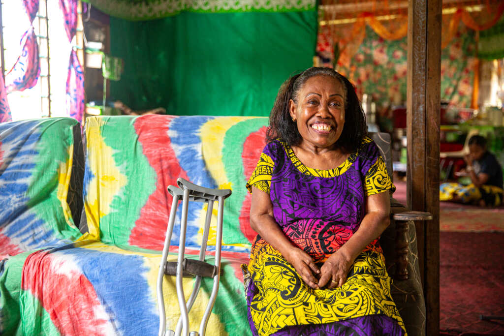 Lusiana Buli sits in her home.