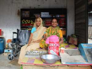 Sarossati (right) and her assistant (left) inside her shop at the local market. 