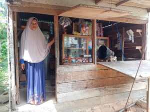Asma standing next to a kiosk