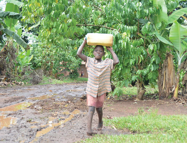 An image of a child carrying water