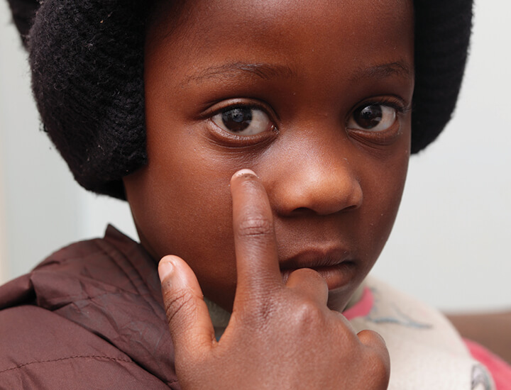 Camille touching her face