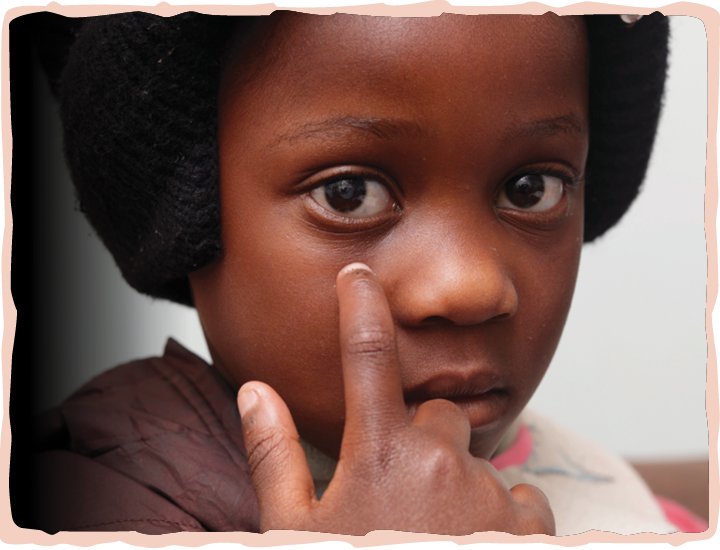 A photo of Camille pointing at her eye