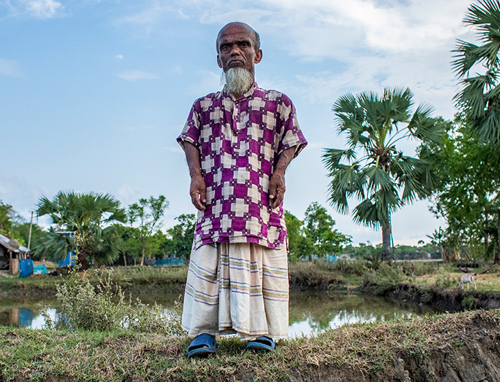 A full body image of a man standing on a hill