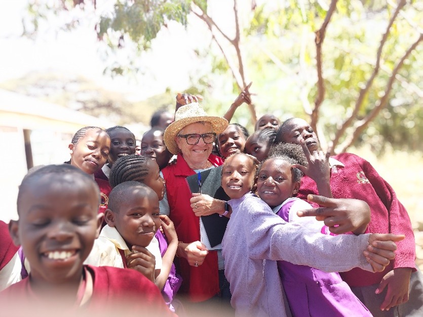 Ascension, Senior Program Coordinator at CBM Australia, is warmly welcomed by students at one of 30 schools where Health Clubs are teaching children about hygiene, handwashing, and disease prevention.
