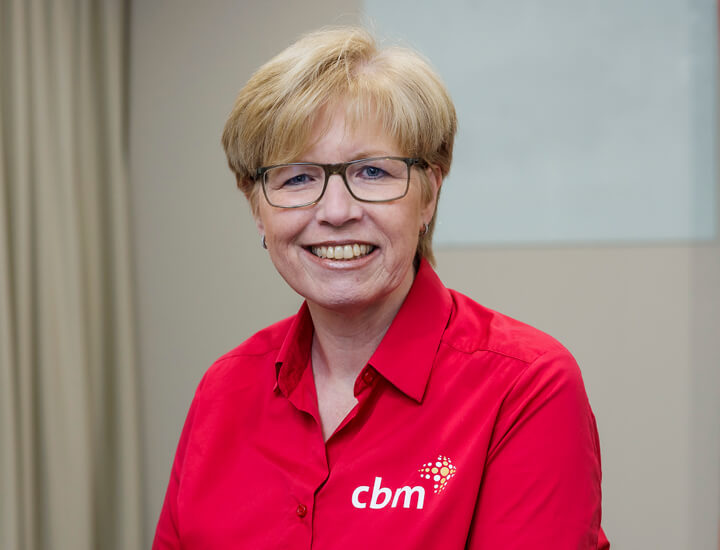Smiling woman in red CBM shirt