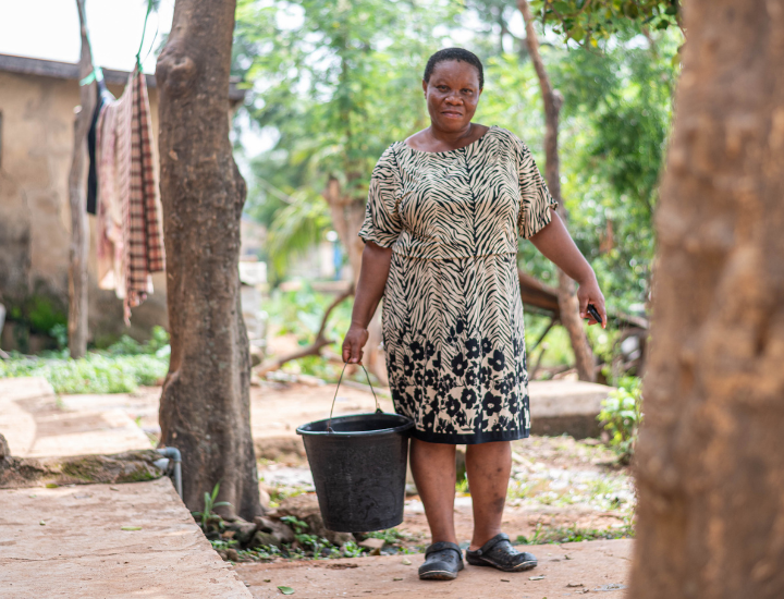 Chizoram holding a bucket of water