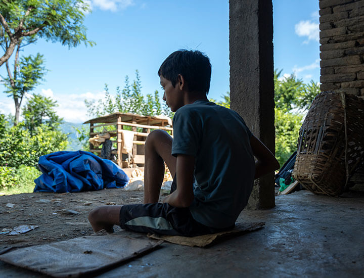 Boy with one leg looking out into the distance